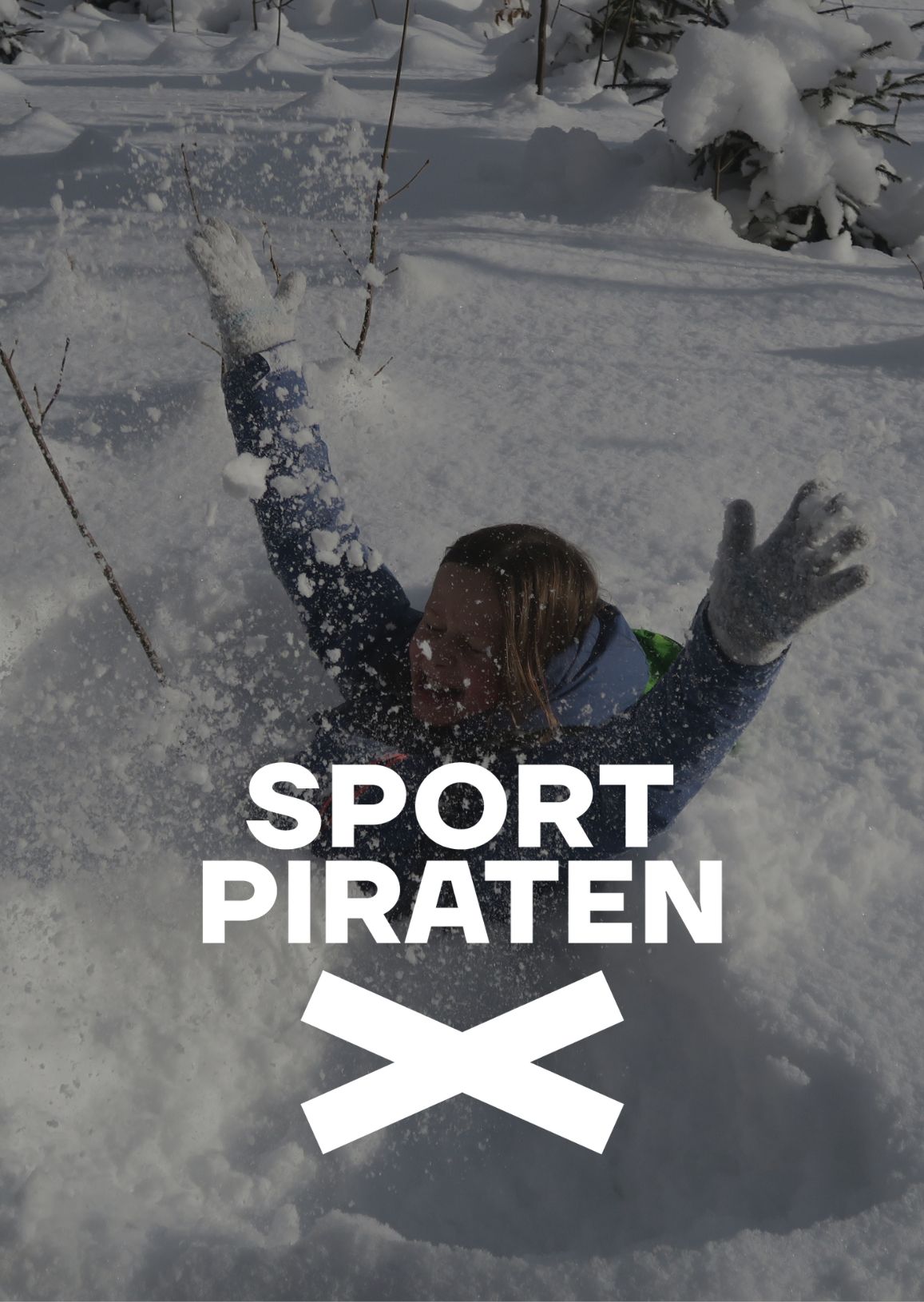 A child plays in the snow. Almost submerged and laughing—full of fun.